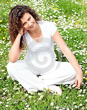Young beautiful girl in flower field