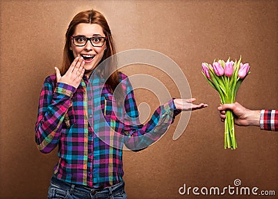 Young beautiful girl gives a bouquet of tulips man