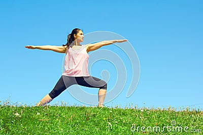 Young Beautiful Mixed Race Woman Doing Yoga Warrior Pose