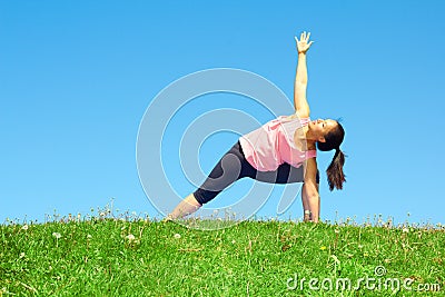 Young Beautiful Mixed Race Woman Doing Yoga Warrior Pose