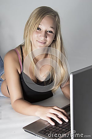 Young Beautiful Teenage girl type on laptop