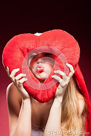 Young beautiful woman with big red heart