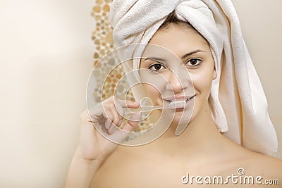 Young beautiful woman brushing her teeth