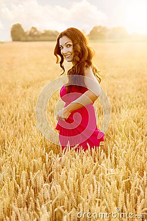 Young beautiful woman in field of wheat