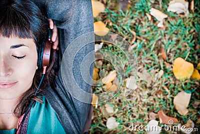 Young beautiful woman listening to music autumn