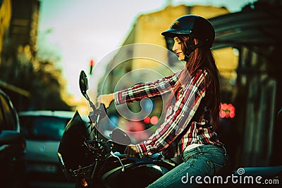 Young beautiful woman on motorcycle