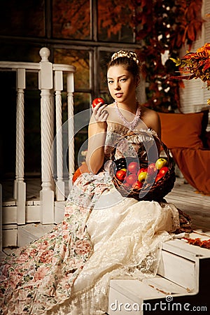 Young beautiful woman in vintage dress on autumn porch. Beauty g