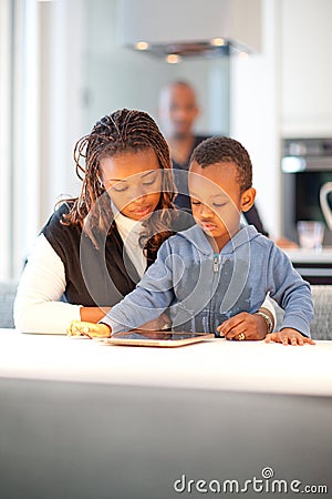 Young black family in fresh modern kitchen