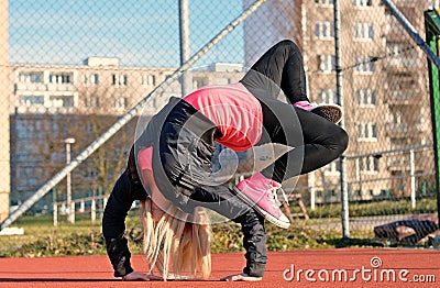 Young blond girl dancing break dance