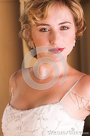 Young blonde bride in white