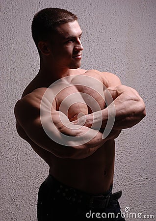 Young bodybuilder showing muscles