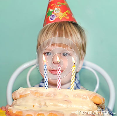 Young boy blowing birthday candles