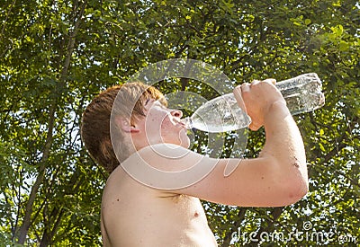 Young boy drinks water out