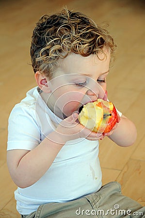 Young boy eating apple