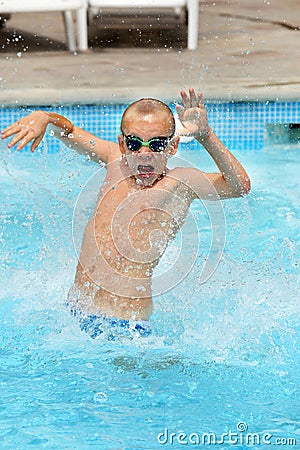 Young boy kid jumping in the pool