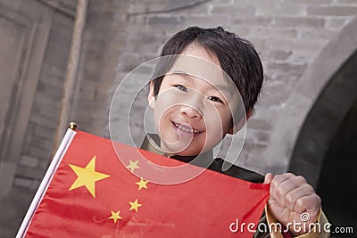 Young Boy in Traditional Courtyard with Chinese Flag