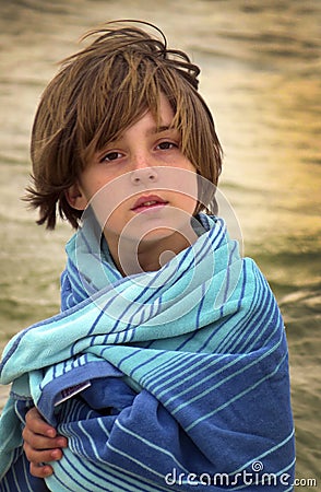 Young Boy Wrapped Up At Beach