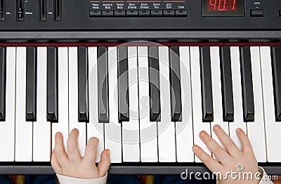 Young boys hands on an electronic piano or keyboard