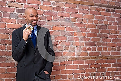 Young business man drinking wine and smiling