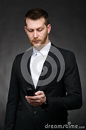 Young business man looking at phone