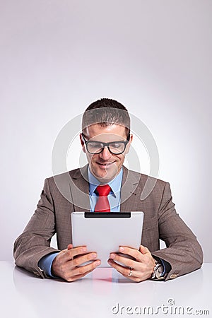 Young business man reading from tablet