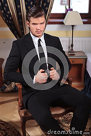 Young business man sits on chair
