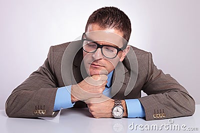 Young business man sleeps on his fists at office