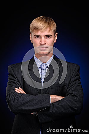 Young business man standing with crossed arms