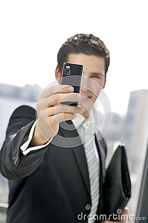 Young business man takes a picture