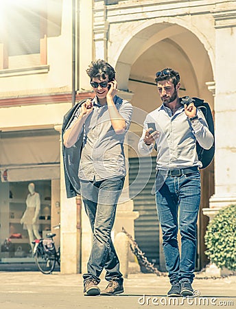 Young business men in the city main square with smartphone