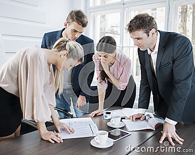 Young business people brainstorming at conference table in office