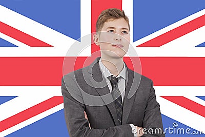 Young businessman with arms crossed over British flag