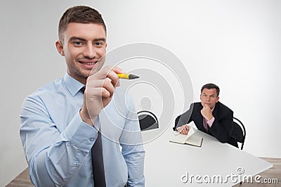 Young businessman holds marker writing, drawing