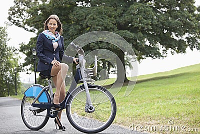 Young businessman riding bicycle while commuting to work