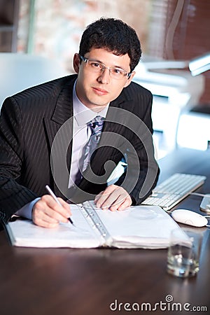 Young businessman signing a document