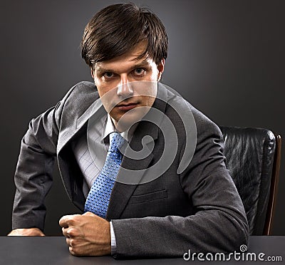 Young businessman sitting behind the desk