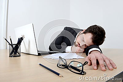 Young businessman sleeping on the office desk
