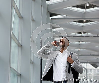 Young businessman smiling and calling by mobile phone