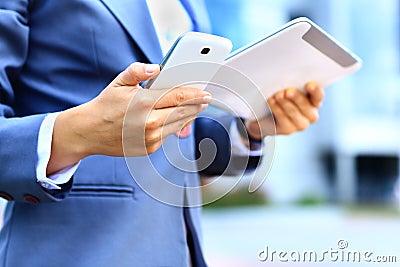 Young businesswoman using digital tablet and mobile phone