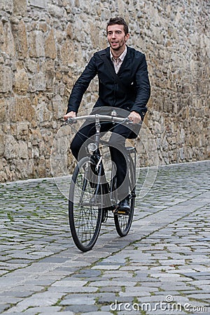 Young casual business man riding his bike