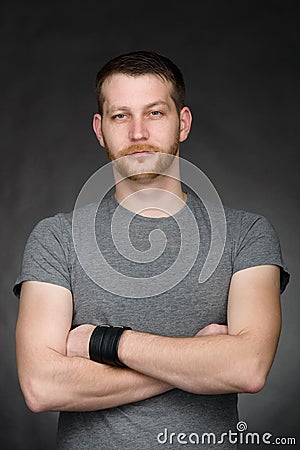 Young casual dressed student man with arms crossed