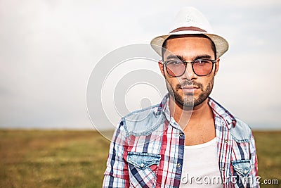 Young casual man wearing hat and glasses