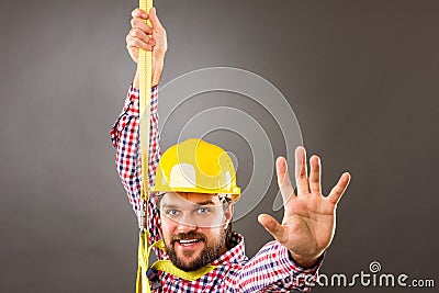 Young construction man withhard hat wearing a fall protection h