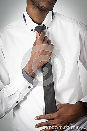 Young Corporate business man adjusting his tie