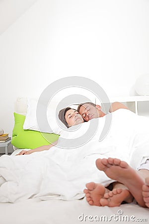 Young couple enjoying a relaxing day in bed