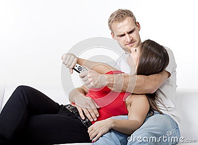 Young couple fighting over remote control