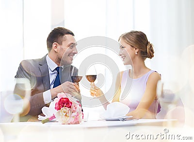 Young couple with glasses of wine at restaurant