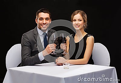 Young couple with glasses of wine at restaurant