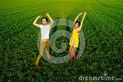 Young couple having fun on the green field
