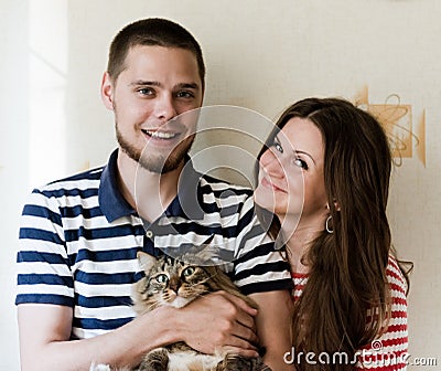 Young couple at home with their cat
